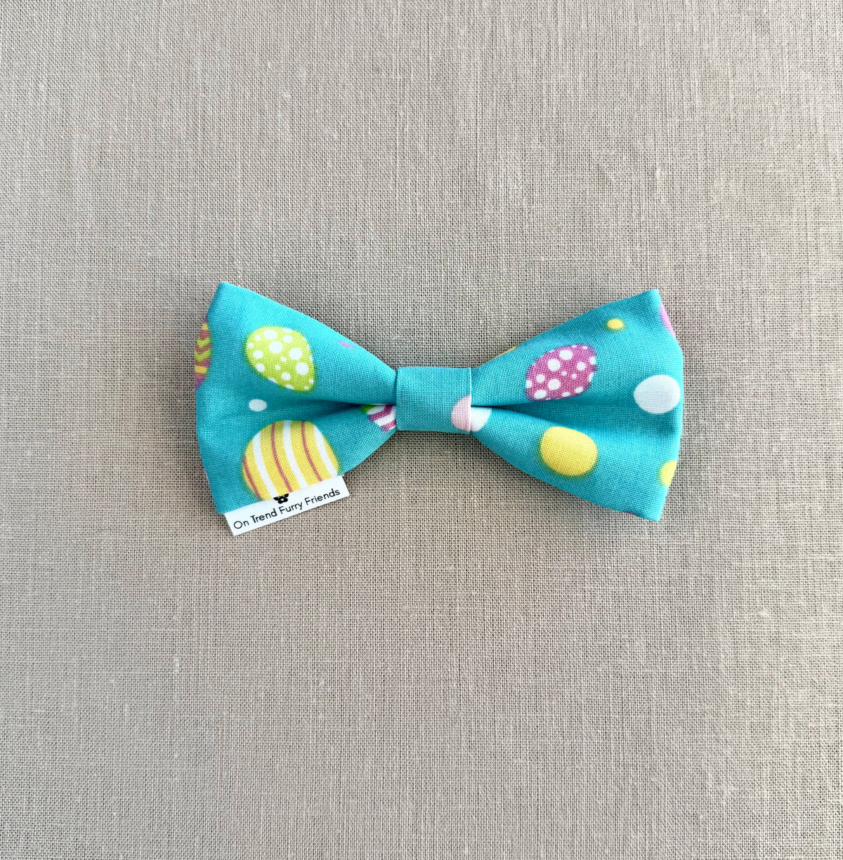 Bright Easter Eggs on Aqua Background in Scarves and Bows