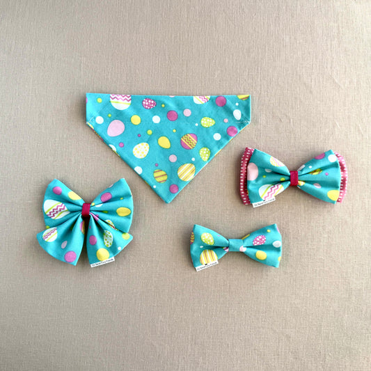 Bright Easter Eggs on Aqua Background in Scarves and Bows
