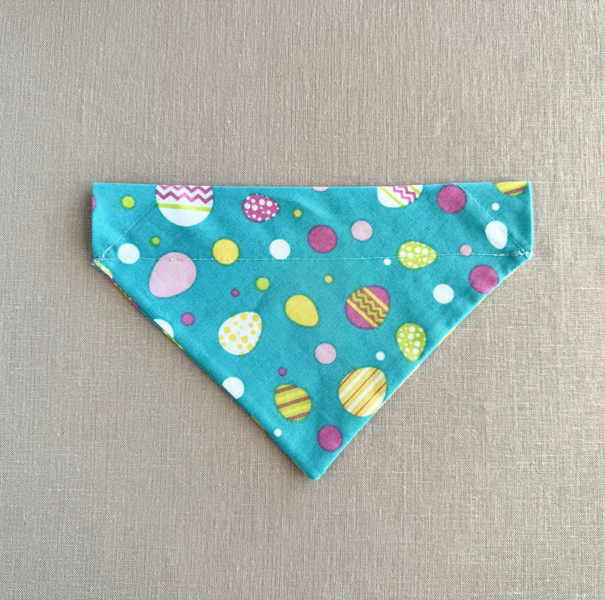 Bright Easter Eggs on Aqua Background in Scarves and Bows