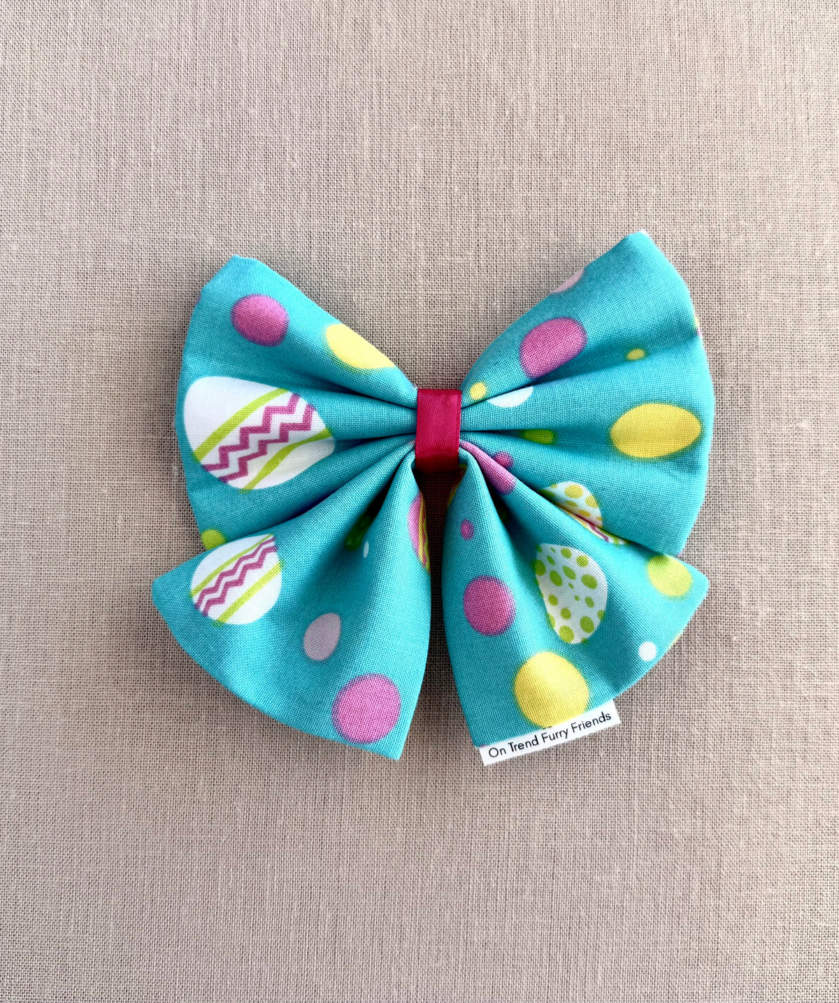 Bright Easter Eggs on Aqua Background in Scarves and Bows